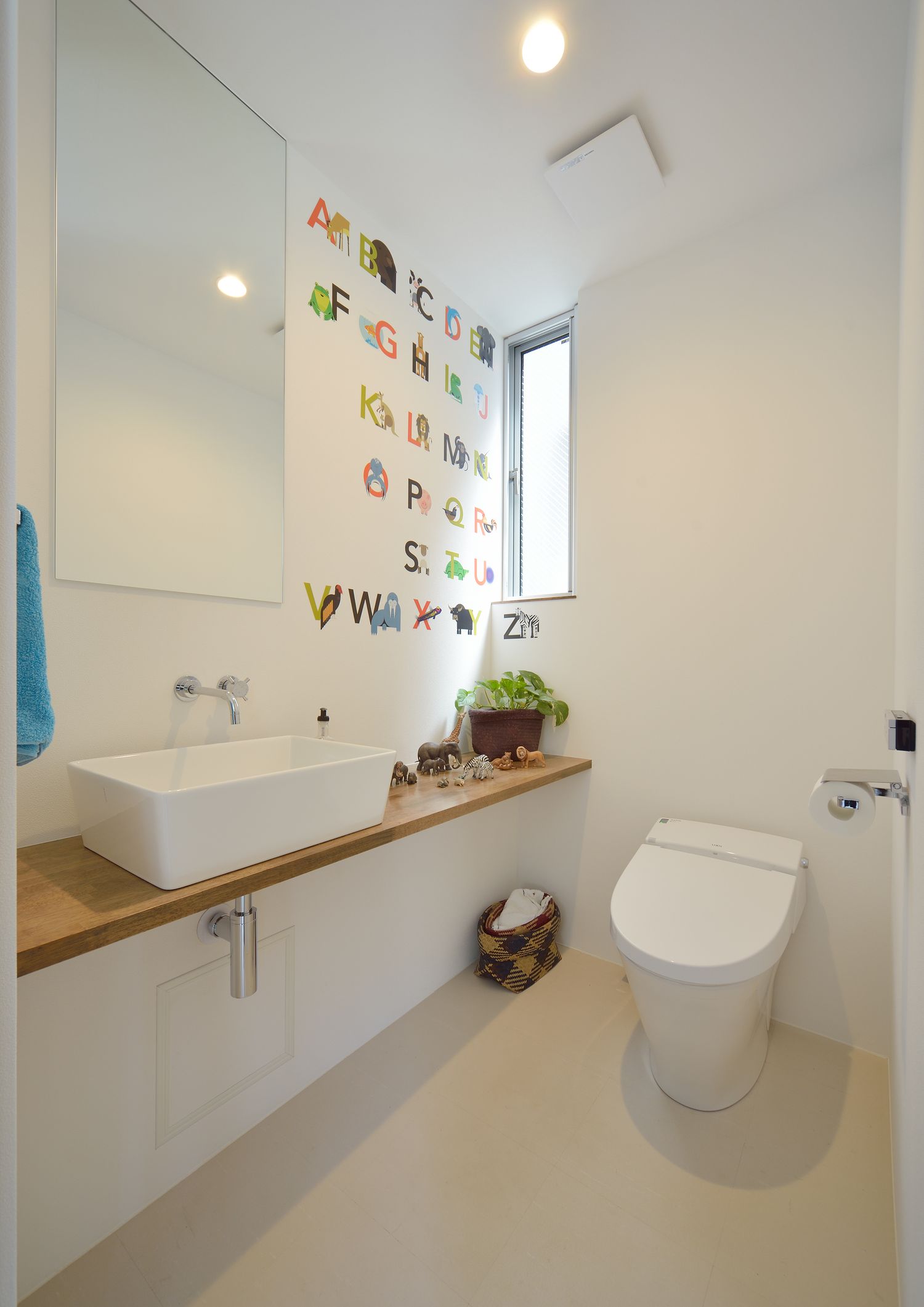 手洗いカウンター付きの明るいトイレ・デザイン住宅