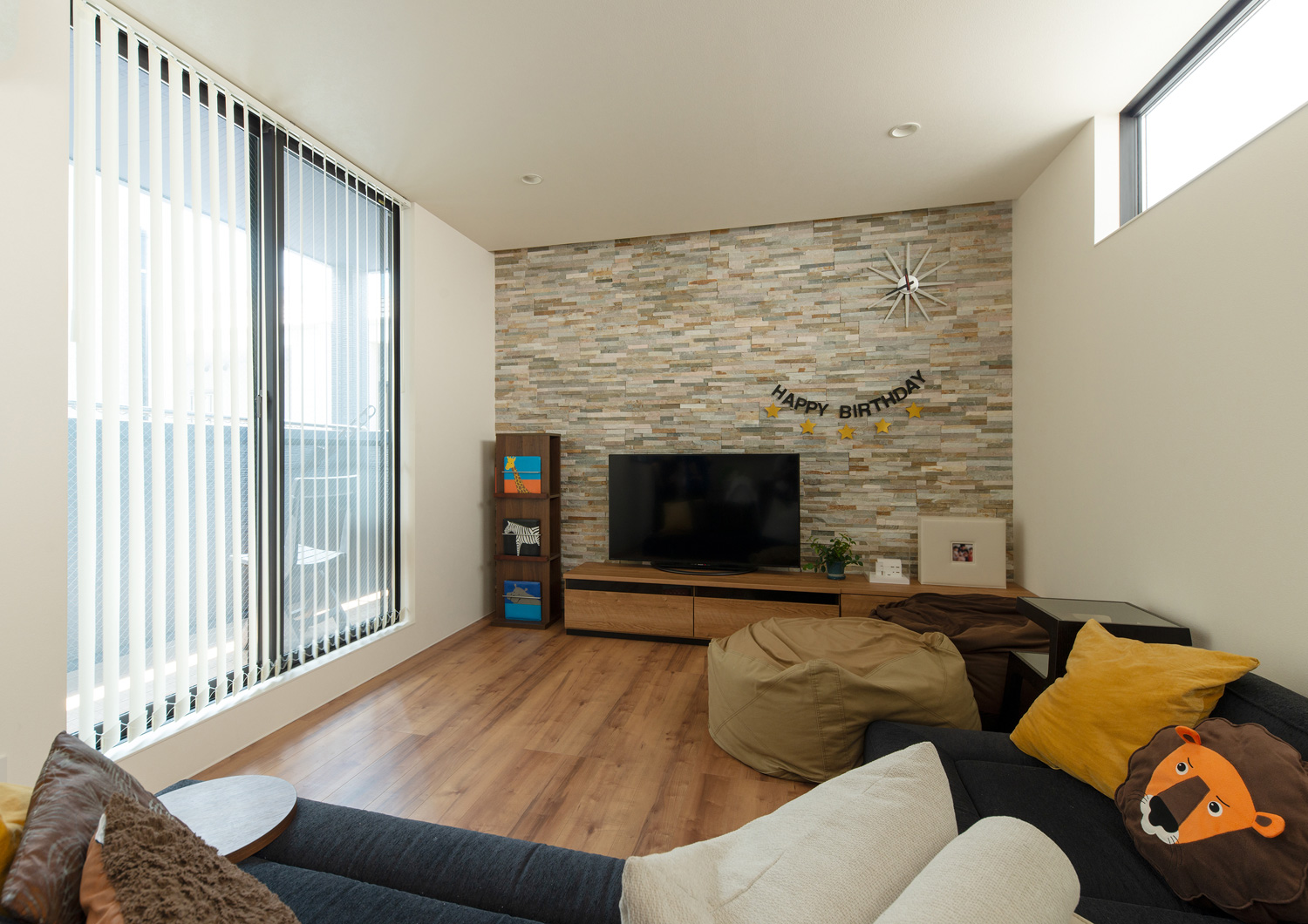 タイルのアクセントウォールがあり、ベランダに繋がる窓があるLDK・デザイン住宅 注文住宅・デザイン住宅建築実例_『CASE655 群青』_LDK