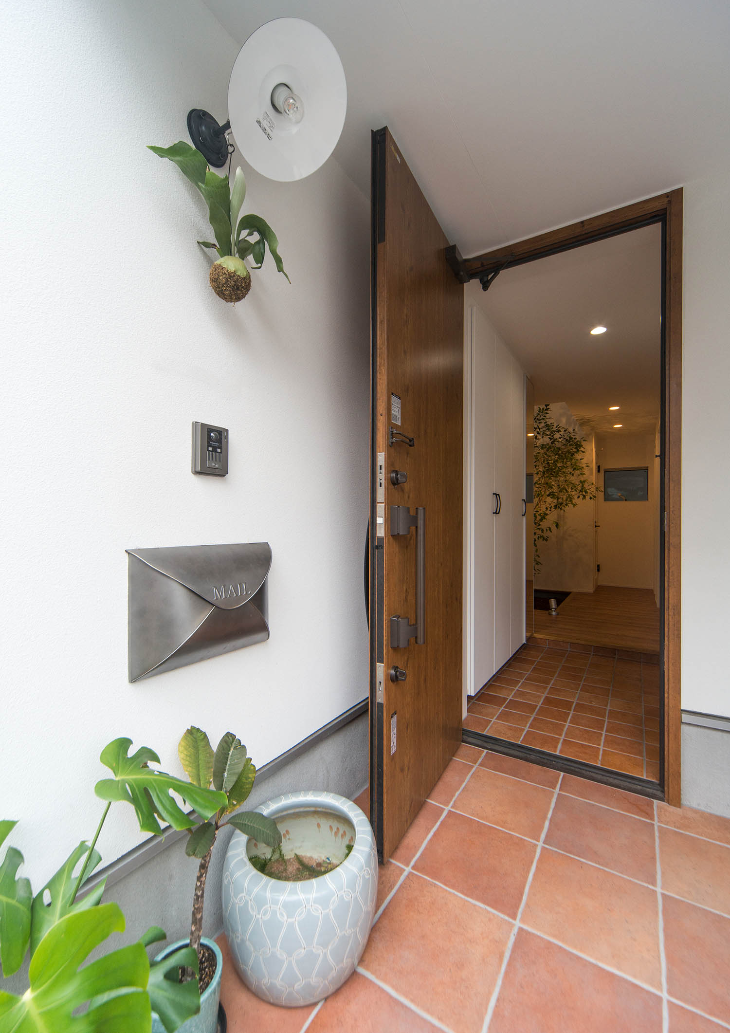 木の玄関扉を開けて室内の様子が見える玄関ポーチ・デザイン住宅 注文住宅・デザイン住宅建築実例_『CASE674 Gardenのある家』_玄関