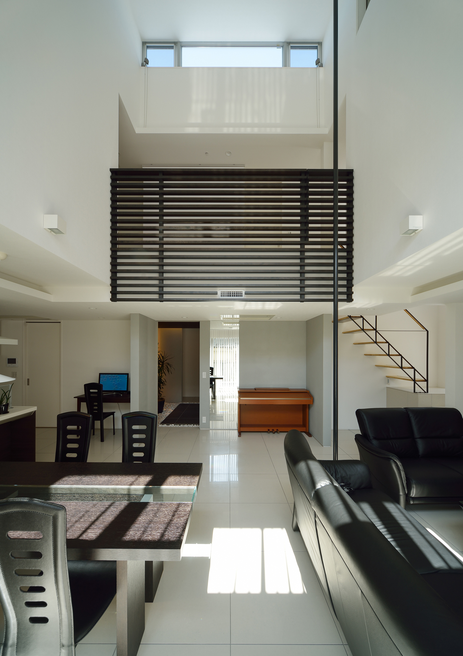 ピアノを置くスペースやオープンなワークスペースがある吹き抜けのおしゃれなLDK・デザイン住宅