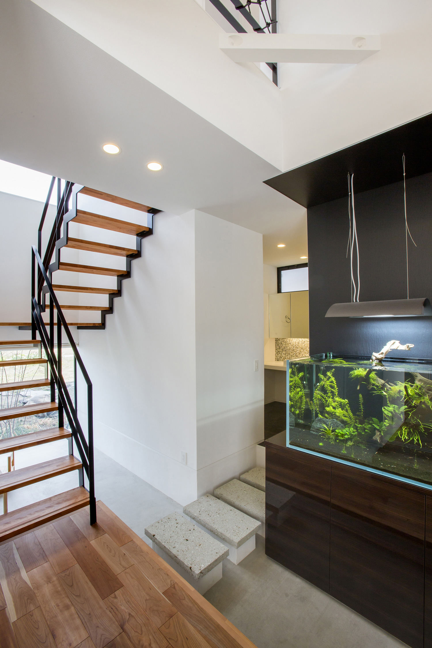 水槽が置いてあるモルタルの吹き抜け玄関・デザイン住宅