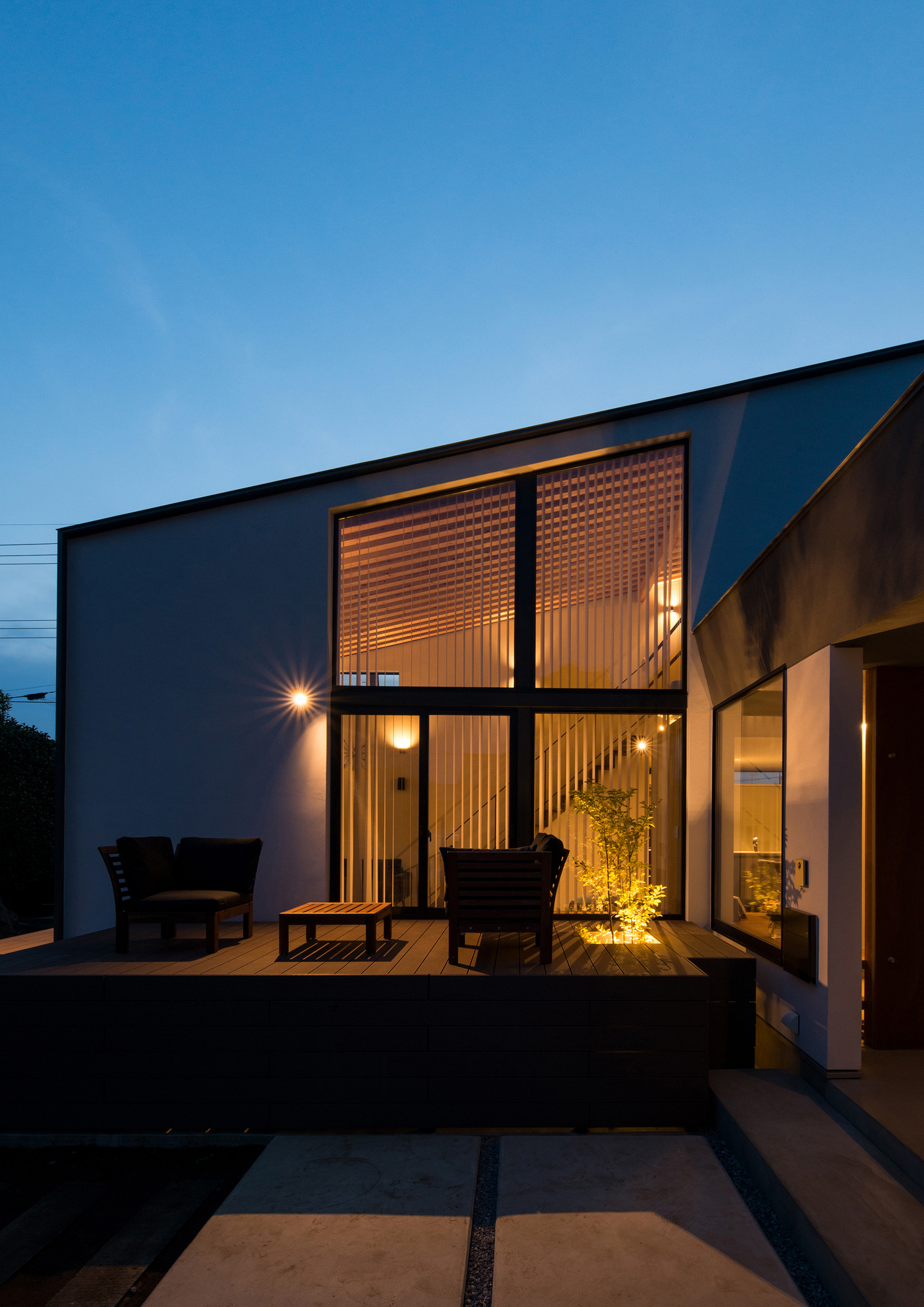 テラスに面した大きな窓から光が漏れる斜め屋根の家の外観・デザイン住宅 注文住宅・デザイン住宅建築実例_『CASE573 次代の家』_外観