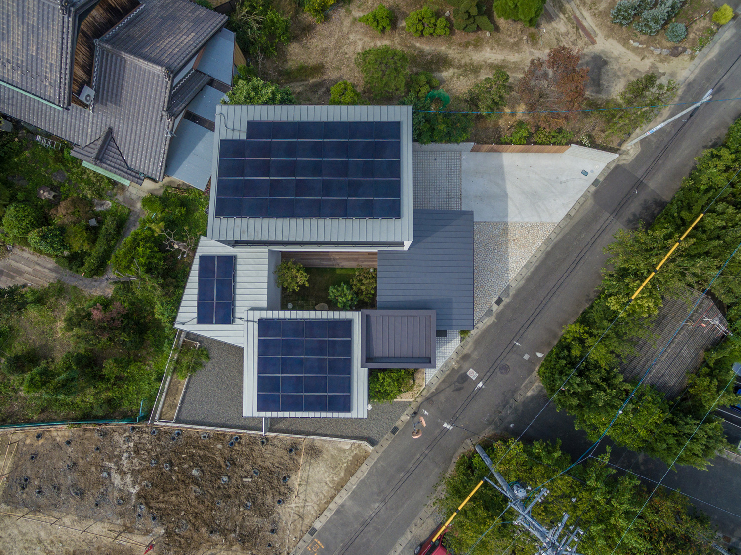 中庭が中心となった、屋根に太陽光パネルを取り付けた家を上から見た様子・デザイン住宅 注文住宅・デザイン住宅建築実例_『CASE576 回廊の家』_外観