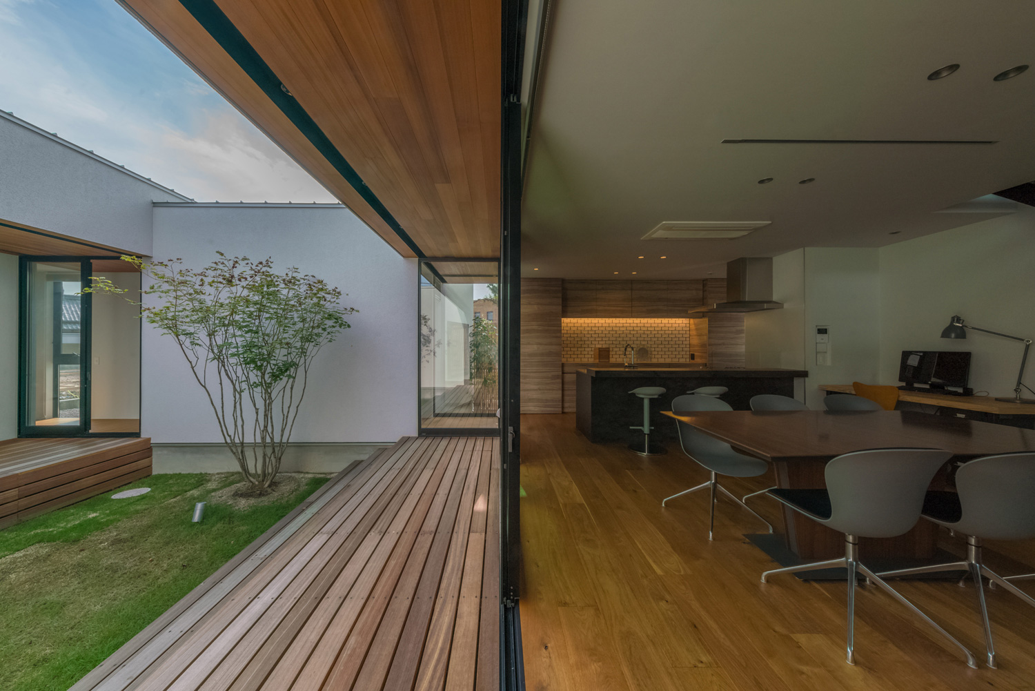 LDKと中庭のウッドデッキがフラットに繋がるデザイン・デザイン住宅 注文住宅・デザイン住宅建築実例_『CASE576 回廊の家』_中庭
