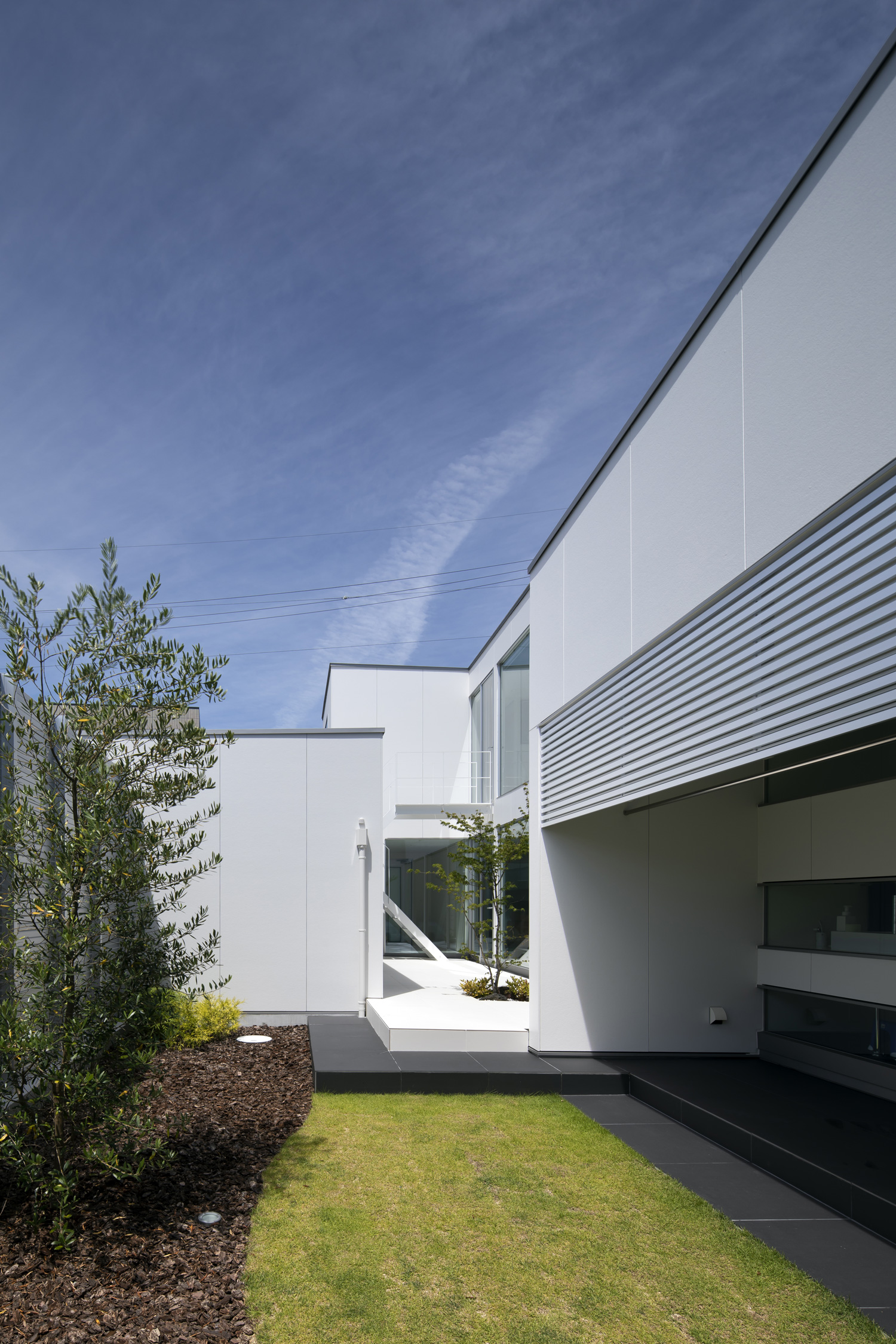 芝生や植栽がある庭から、中庭が見える住宅・デザイン住宅 注文住宅・デザイン住宅建築実例_『CASE627 HOUSE . GARAGE HOUSE』_中庭