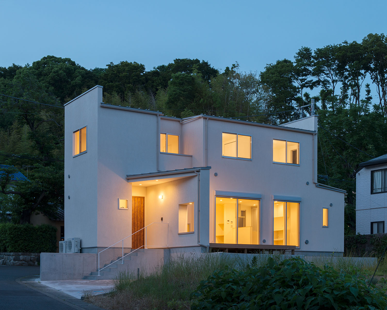 窓から光が漏れる庭付きの白い外壁の家・デザイン住宅 注文住宅・デザイン住宅建築実例_『CASE550 three box house』_外観