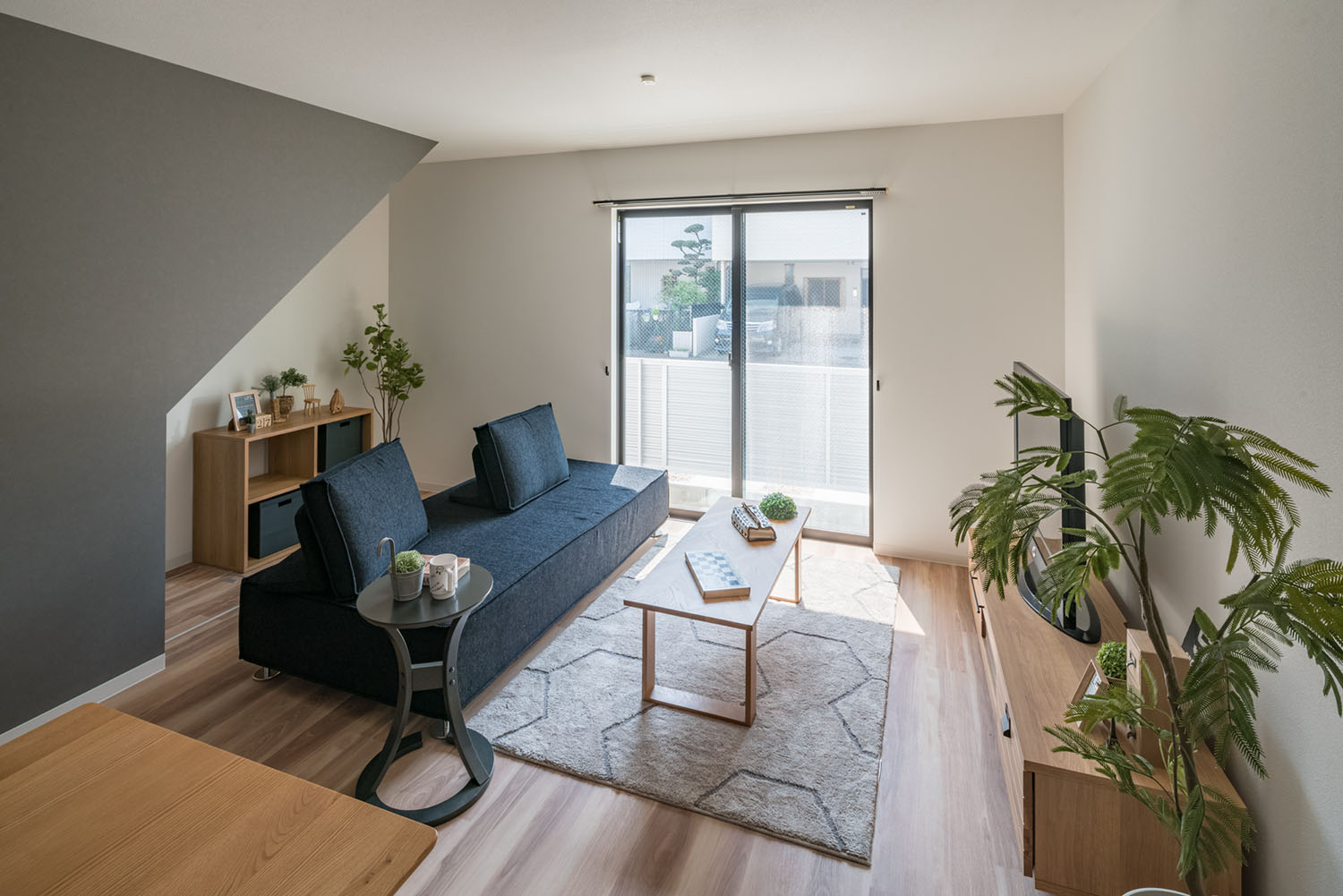 ベランダに繋がる窓がある、青いソファーが置かれたLDK・デザイン住宅 注文住宅・デザイン住宅建築実例_『CASE623 HOUSest-Life+Cafe』_LDK