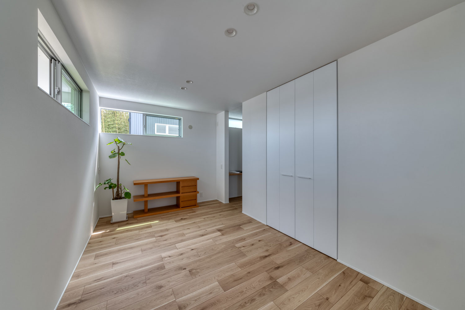 白い壁とフローリングの、スリット窓がある部屋・フリーダムアーキテクツの事例 注文住宅・デザイン住宅建築実例_『CASE704 with a view』_寝室