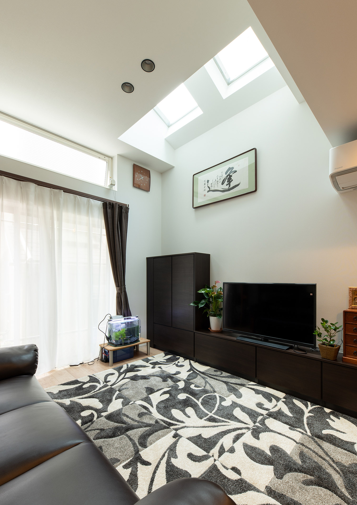 モノクロのカーペットが敷かれている、天窓のあるLDK・フリーダムアーキテクツの事例 注文住宅・デザイン住宅建築実例_『CASE748 バスケットコートのある家』_LDK