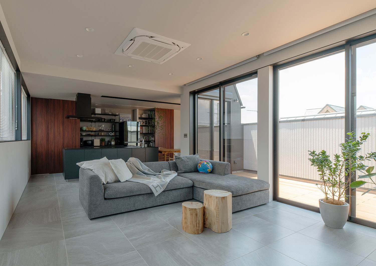 バルコニーとフラットに繋がる、L字型のソファがあるLDK・フリーダムアーキテクツの事例 注文住宅・デザイン住宅建築実例_『CASE748 バスケットコートのある家』_LDK