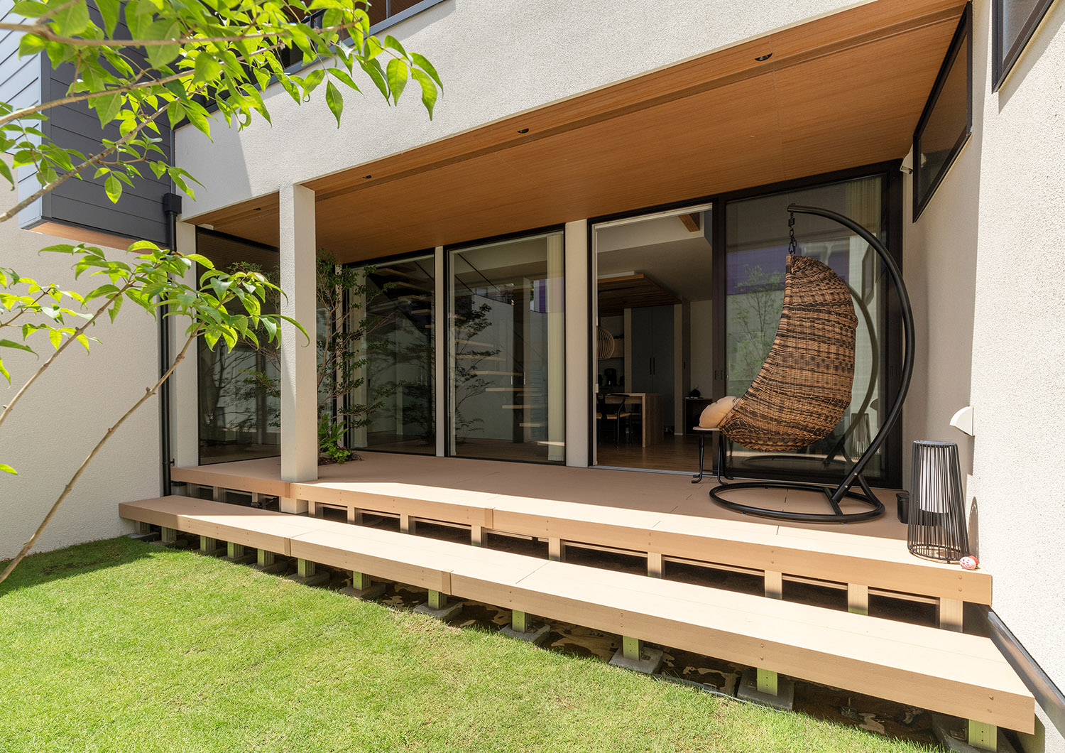 ハンモックチェアがある縁側の先に芝生の中庭がある様子・デザイン住宅 注文住宅・デザイン住宅建築実例_『CASE757 トキノエンガワ』_テラス・バルコニー